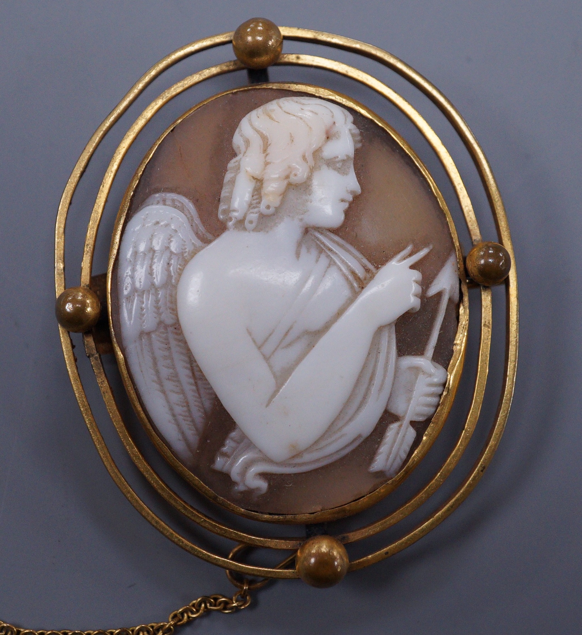 A 19th century gilt metal mounted cameo brooch carved with Cupid, 4.5cm